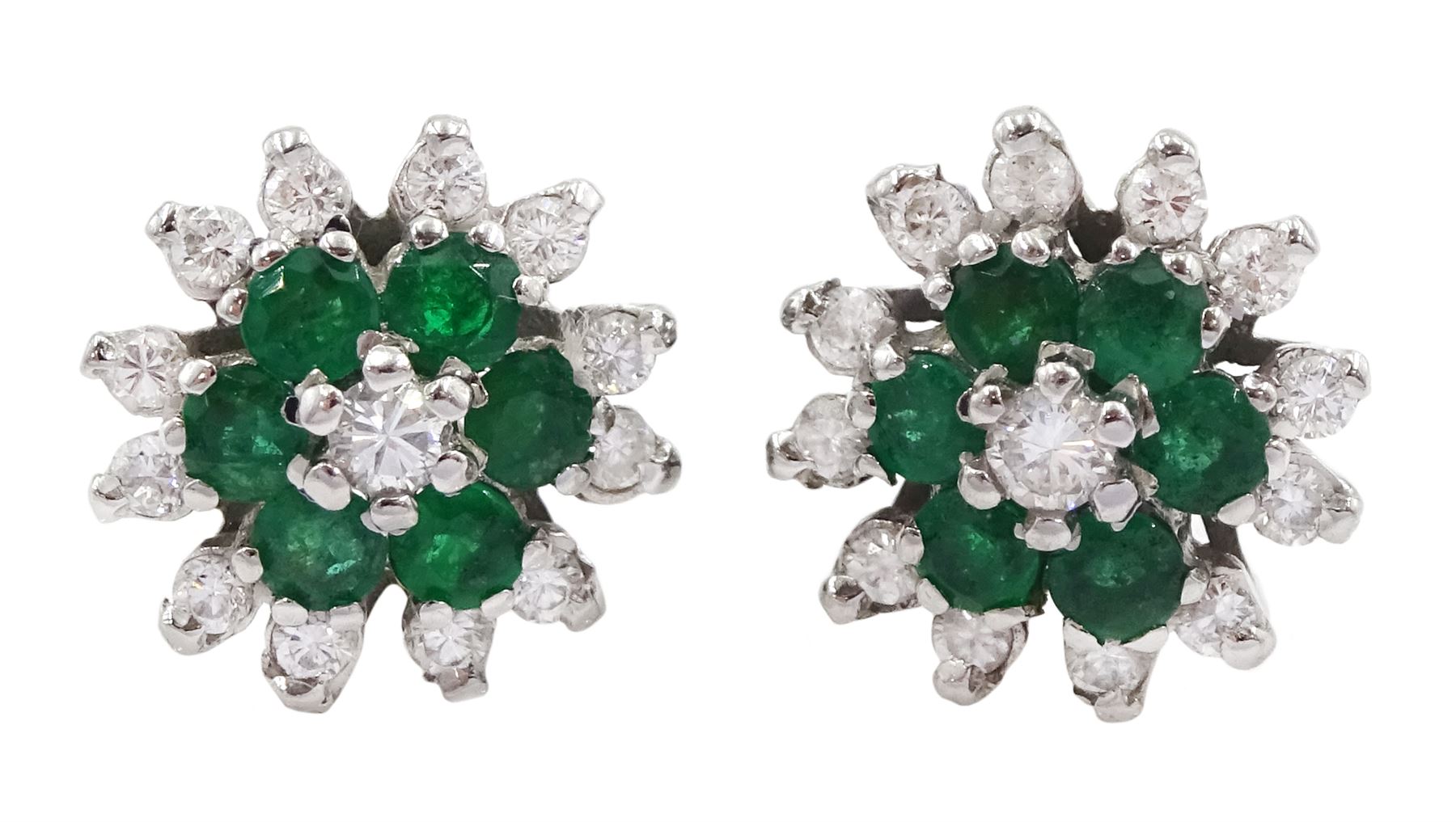 Pair of 18ct white gold emerald and round brilliant cut diamond flower head cluster stud earrings, London 1978 