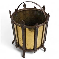 19th/ early 20th century wrought iron and brass coal bucket, of cylindrical form with gothic iron frame, upon five shaped supports, H36.5cm, together with a Georgian wrought iron and pierced brass trivet, with turned elm handle (2)