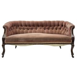 Late 19th century mahogany framed two-seat sofa, upholstered in buttoned pink fabric, on cabriole front supports, on castors 