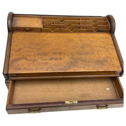 Victorian walnut clerk's desk, raised central section with tambour roll over hinged top, the interior fitted with leather inset writing surfaces, small drawers, document divisions and pen and ink stand, central drawer over double panelled cupboard, flanked by two banks of four graduating drawers, on bracket feet 