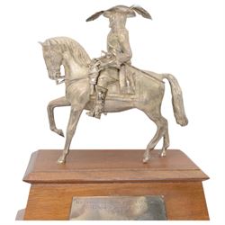 'The Scottish & Newcastle Breweries Handicap Sweepstakes 1972, Won by Warpath, Owned and Bred by Mr Guy Reed, Trained by S Hall, Ridden by A J Russell' - Cast silver figure of a cavalier on horseback 25cm x 21cm on a mahogany plinth with silver plaque 38cm x 33cm overall London 1969 Maker Edward Barnard & Son 