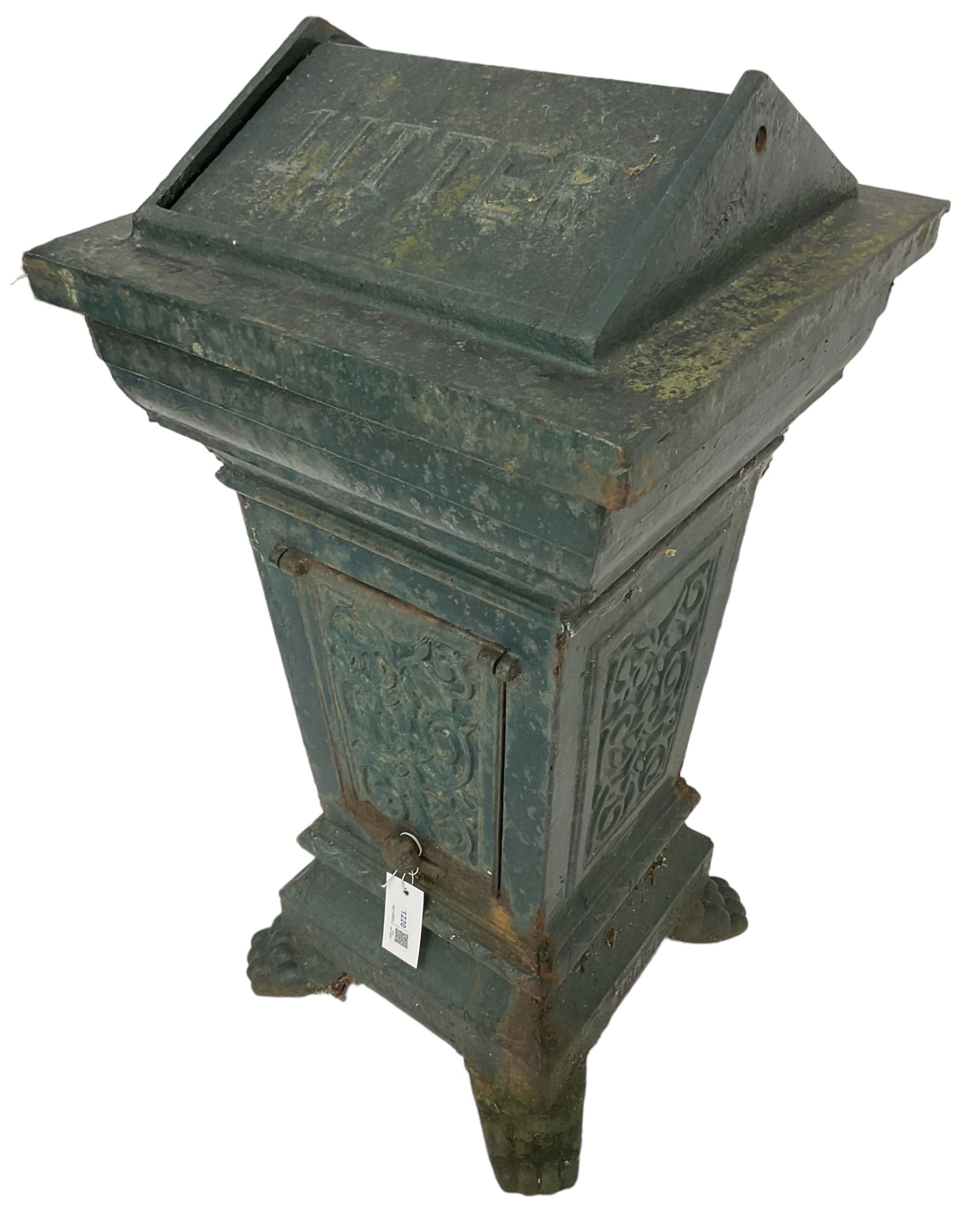 Early 20th century cast iron litter bin, square tapering form with scrolling foliate decoration, on paw feet