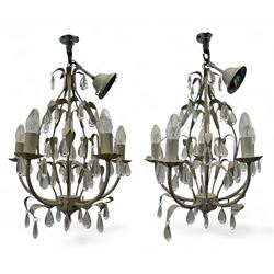 Pair of French design cream-painted metal chandeliers, each with six candle-style lights, ...