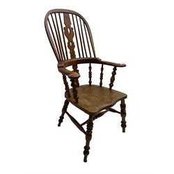 Elm and beech high back Windsor chair,  high hoop back with pierced splat and spindle supports over shaped saddle seat, raised on ring turned supports united by H-stretcher