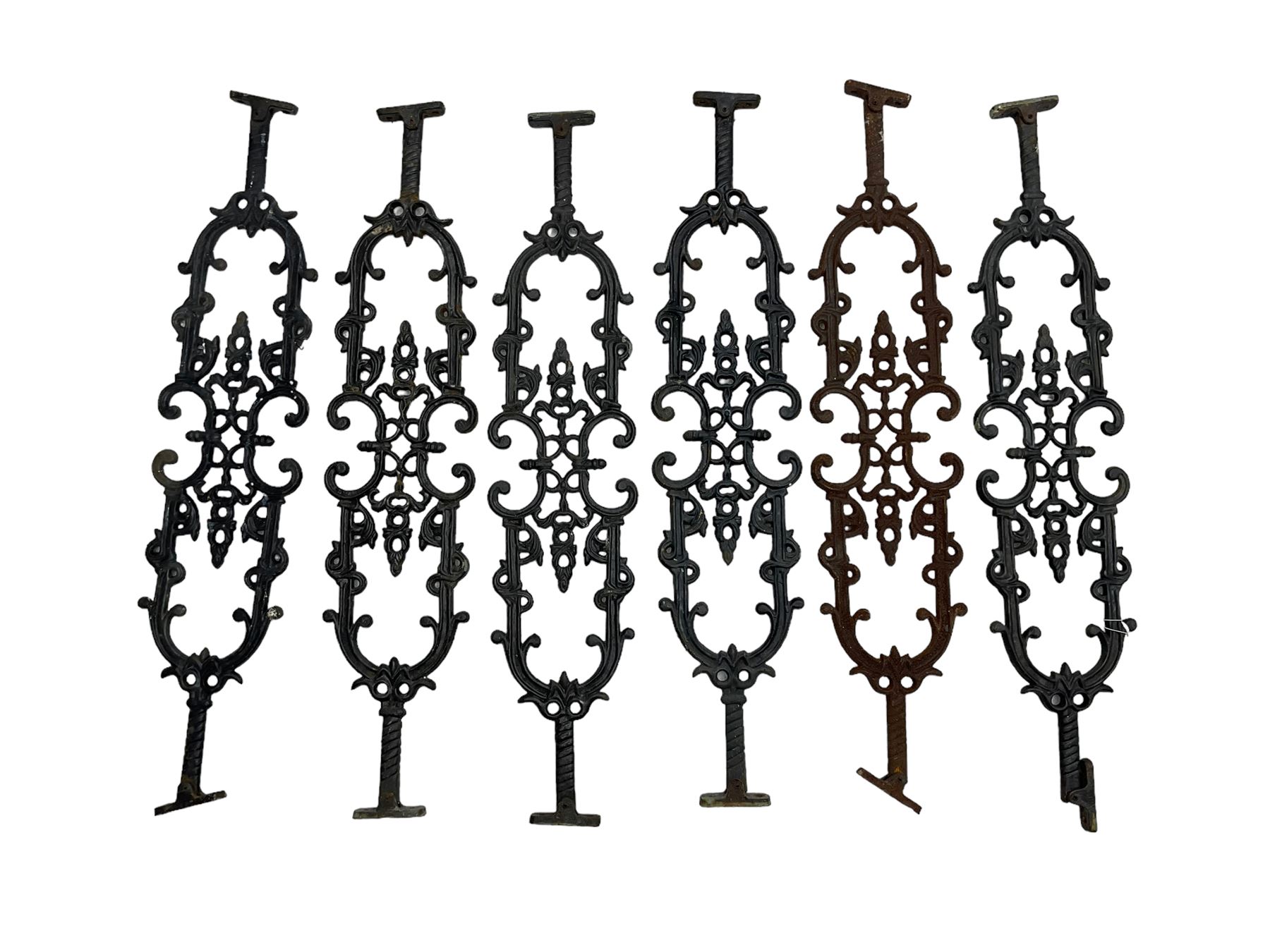 Set of twelve 20th century cast iron staircase baluster rails or balustrade, decorated with foliate scrolls