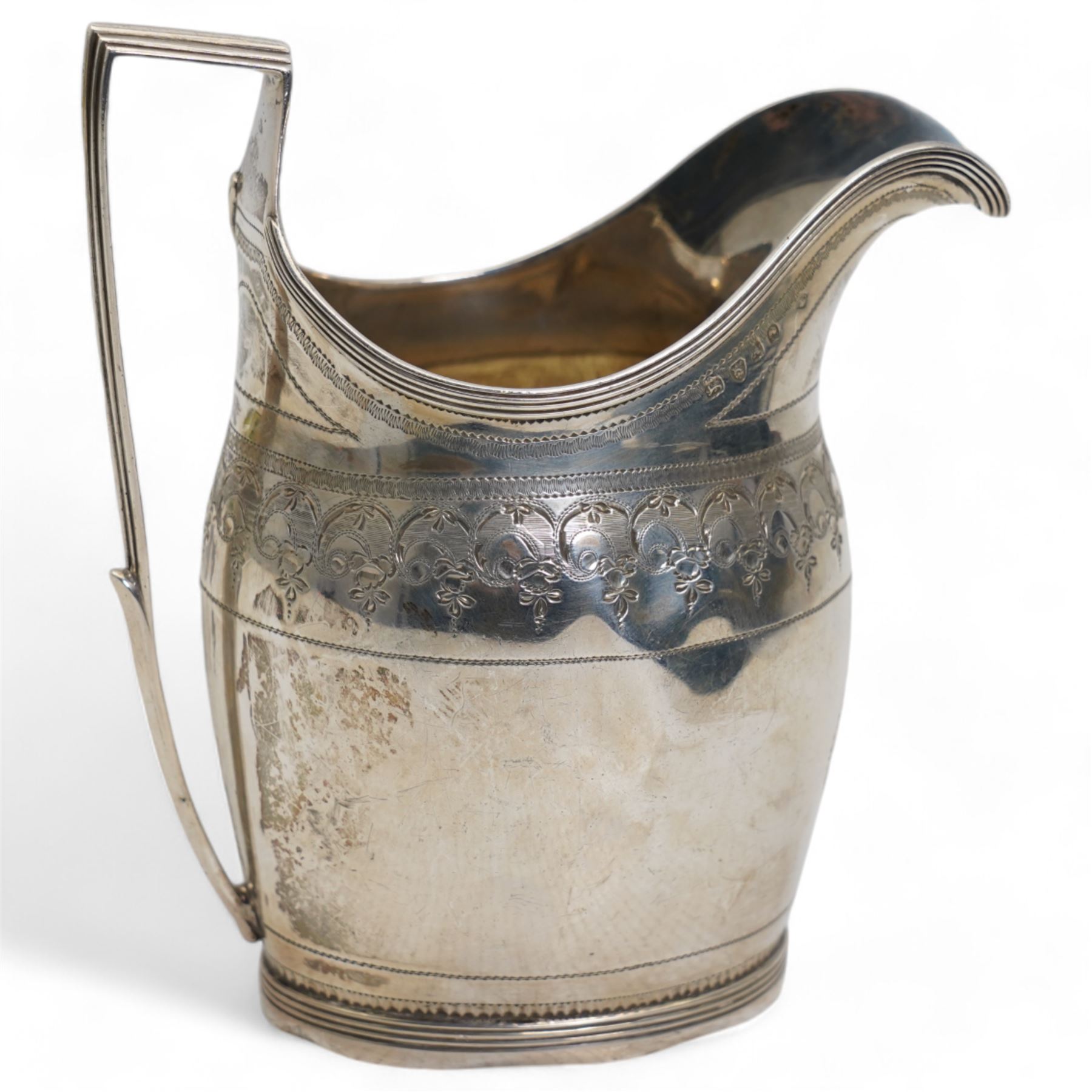 George III silver cream jug with engraved decoration and angular handle London 1796 Maker possibly George Wintle