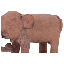 16th century style Javanese terracotta model of an Indian Elephant, with carved saddle, chain around neck and adornment to trunk, H30cm L47cm