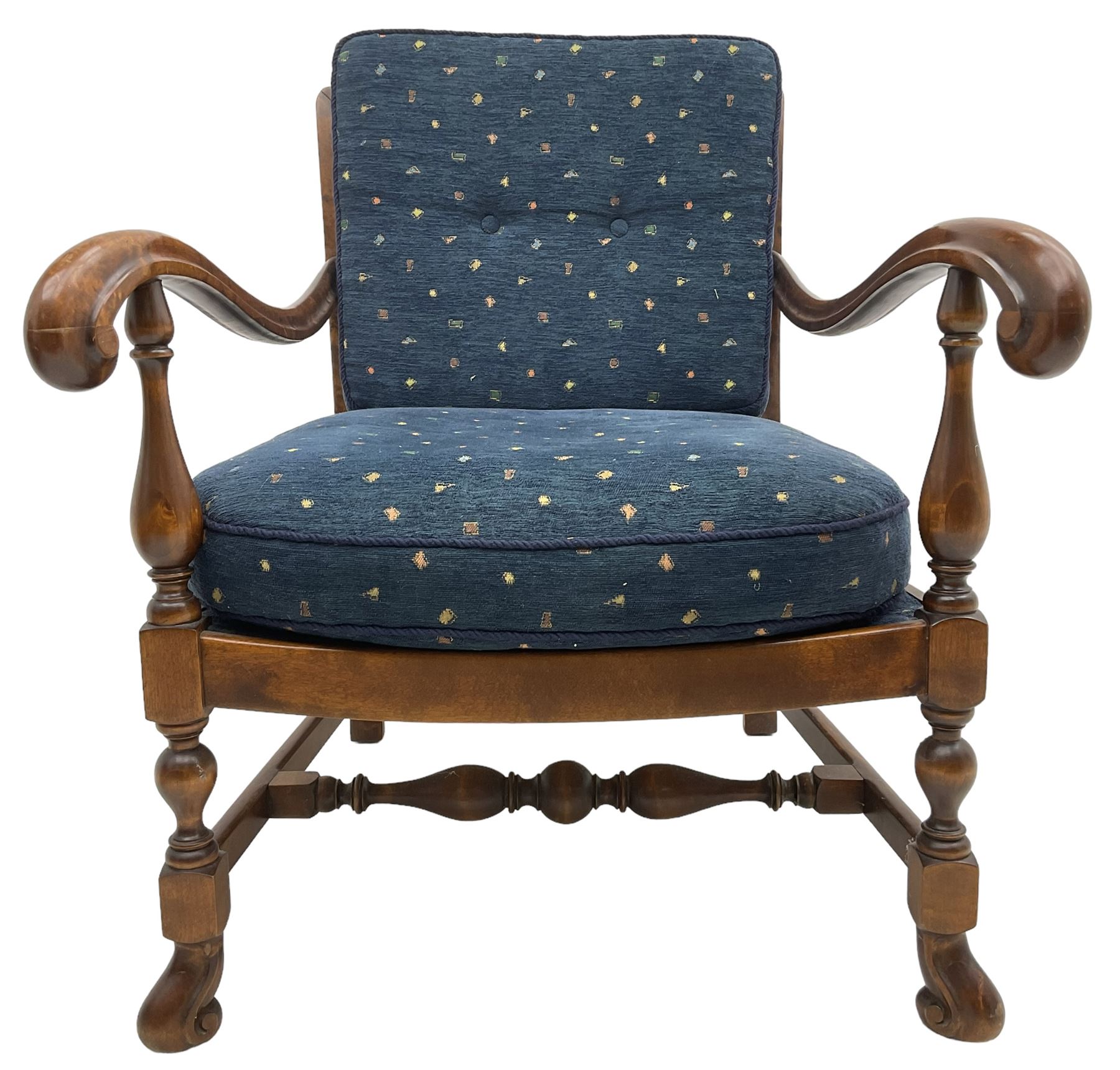 Early 20th century stained beech framed armchair, cane panel back over scrolled arm terminals, raised on turned supports united by turned H-stretcher, with patterned blue upholstered loose back and seat cushions