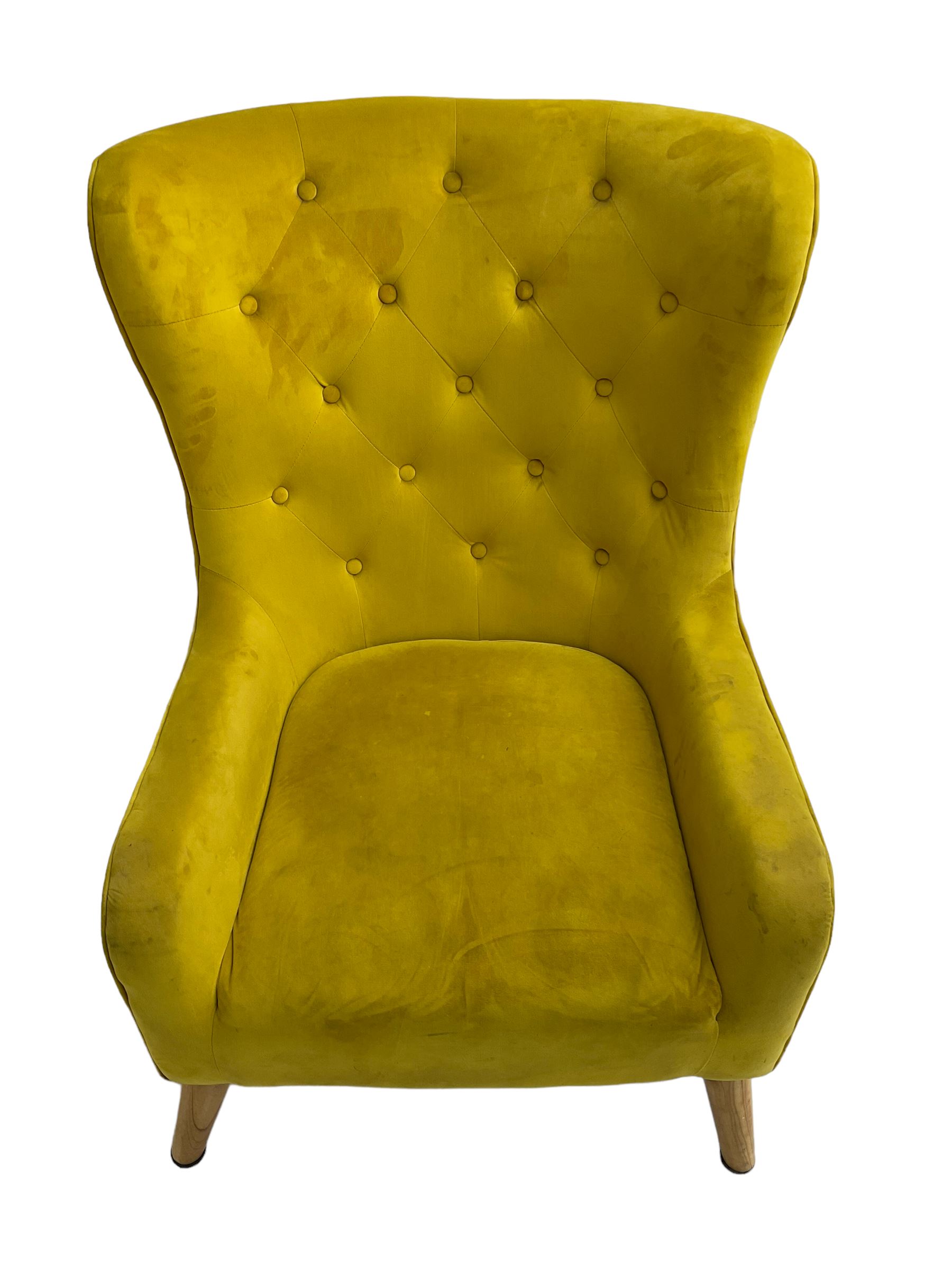 Mid-20th century design armchair, barrel back upholstered in buttoned mustard fabric, on tapering splayed front feet