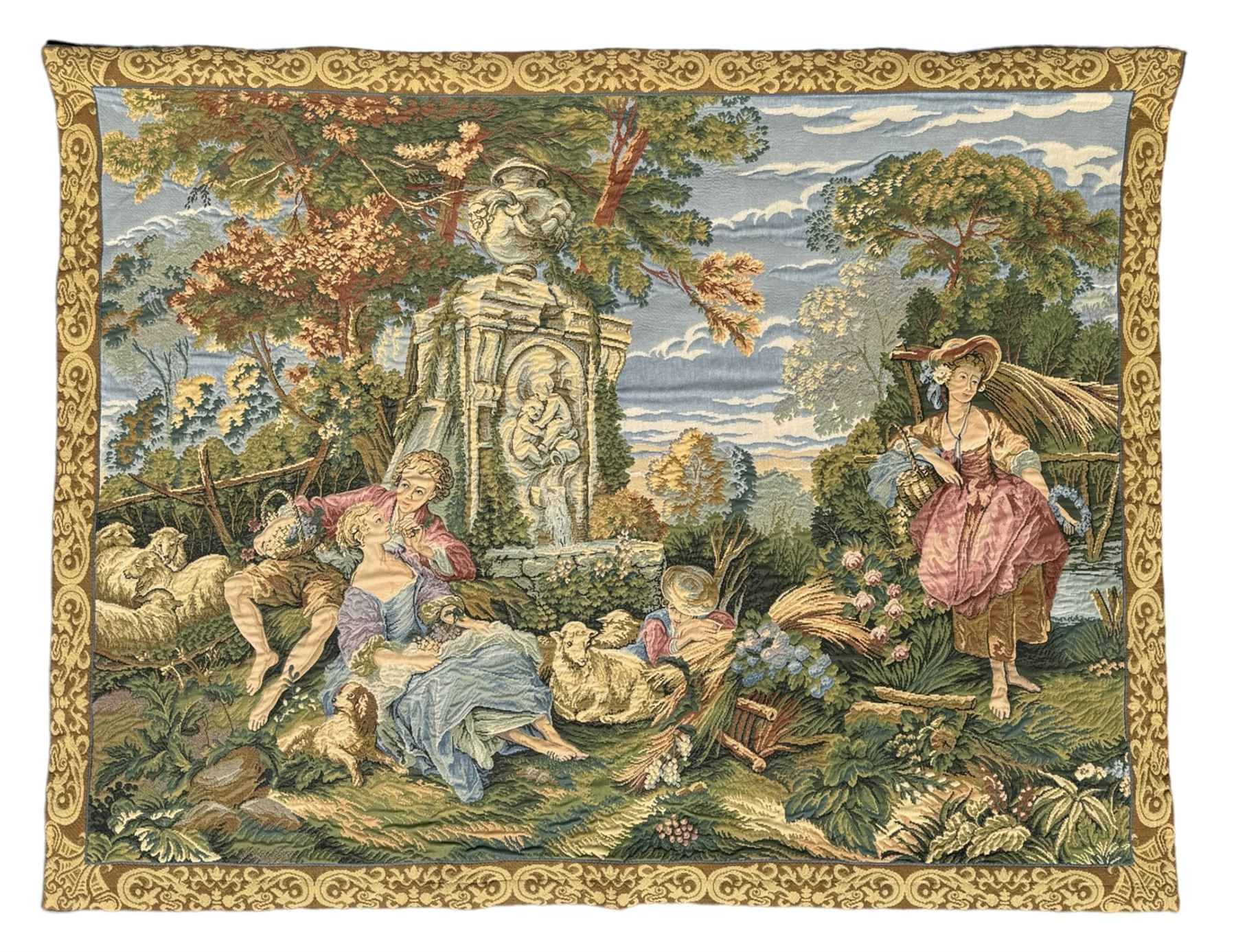 French machine woven tapestry, the scene depicting pastoral life with shepherds and sheep against a backdrop of lush foliage and classical architecture, bordered by a floral and scroll design