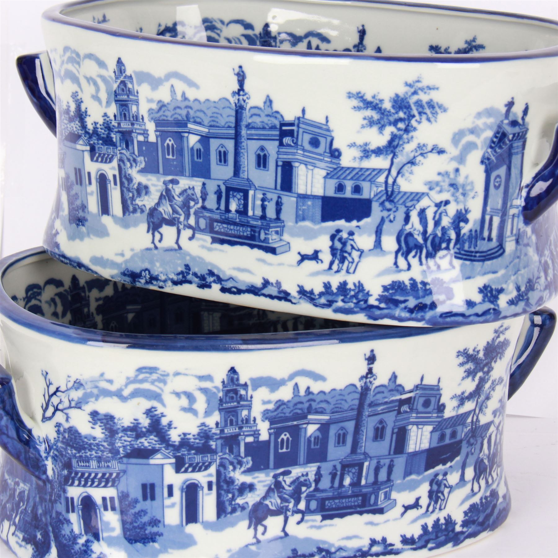 Pair of Victorian style blue and white footbaths, each with twin lug handles and transfer print decorated with city scape, H14cm