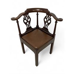 George III mahogany corner elbow chair, curved back rest and shaped arms with scroll carved terminals, on turned supports and pierced scroll carved interlaced splats, drop-in seat upholstered in brown leather, on square supports with inner chamfer and outer moulding 