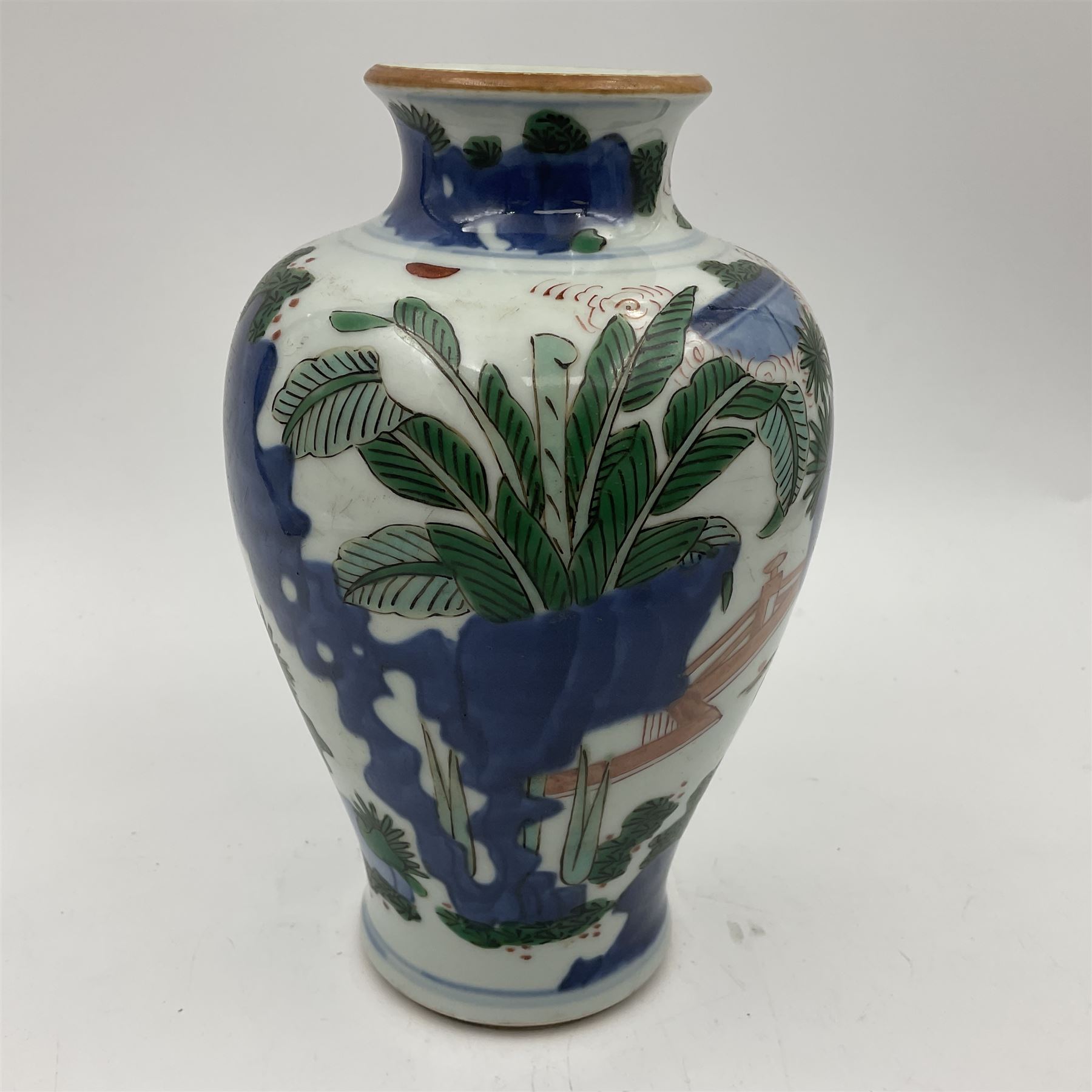 Chinese Wucai vase, of baluster form, decorated with an official and attendants in a garden setting, with crane, fence and rockwork, H19cm