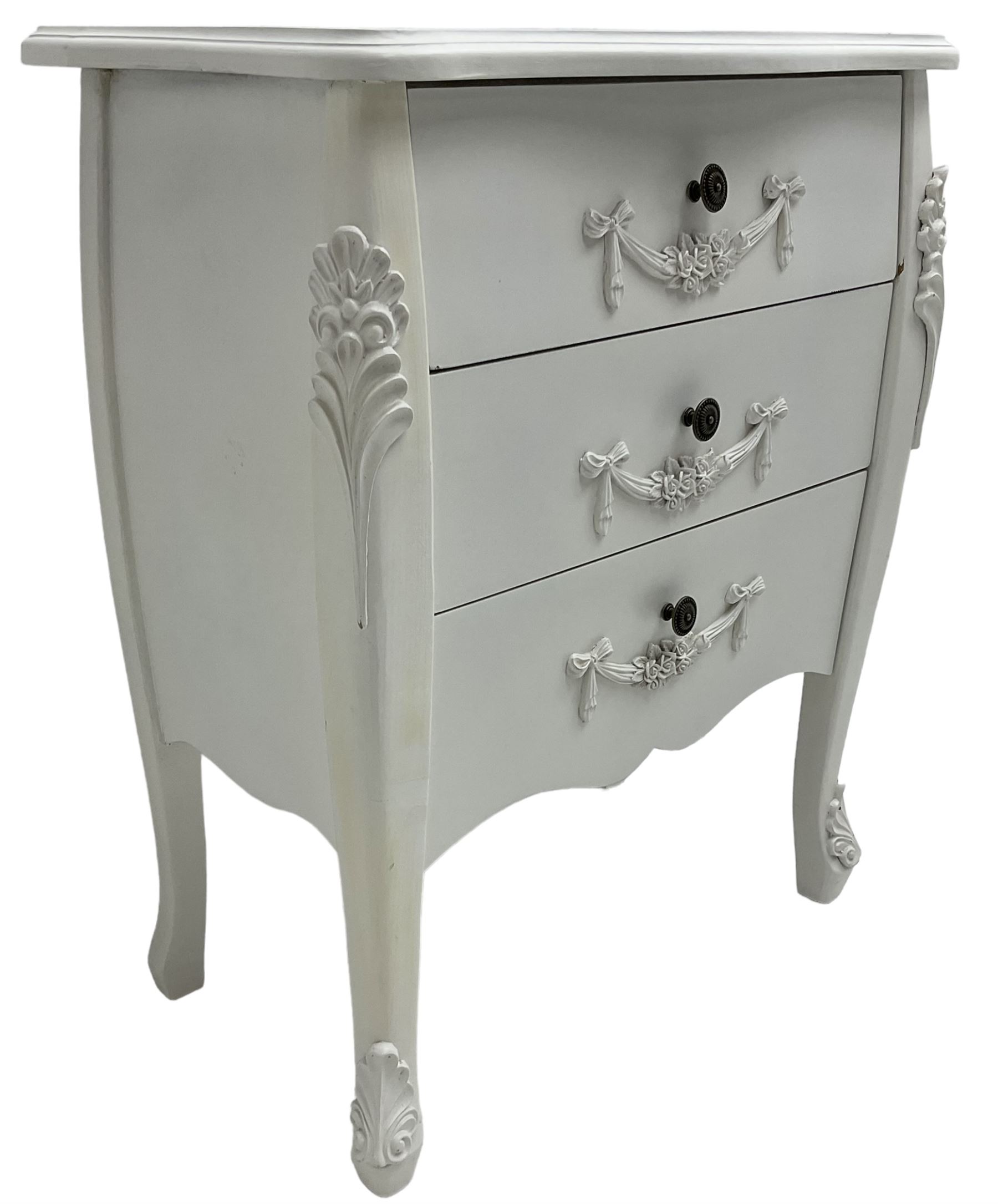 French design white painted chest, shaped top over three drawers, each with applied swags with flower heads, flanked by cabriole uprights with foliate mouldings