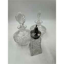 Two cut glass decanters, together with a faceted red glass bottle, cut glass sugar caster with pierced star cover, silver plated stirrup cup, chainmail scarf, plaster ships plaque and a walnut box with mother of pearl cartouche