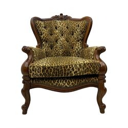 Pair of Victorian design stained beech armchairs, upholstered in leopard print fabric, with carved top rail over button-tufted backrest, scroll arms, serpentine front rail, raised on cariole supports