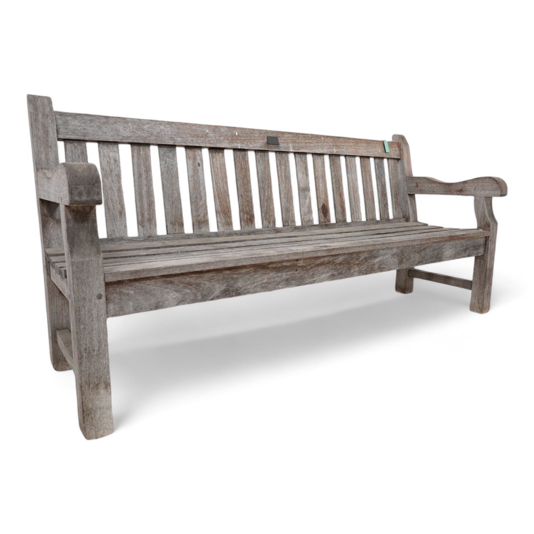 'J.V.T. Ampleforth' - teak garden bench, plain cresting rail with applied maker's plaque over slatted back and seat, on square supports 