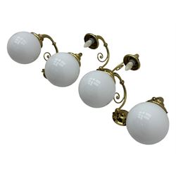 Two brass double-arm wall mounted lights, each with frosted glass globes and scrolled arms (W50cm, D26cm, H31cm); matching central double-arm light with candle-style fittings (W42cm, D24cm, H22cm)