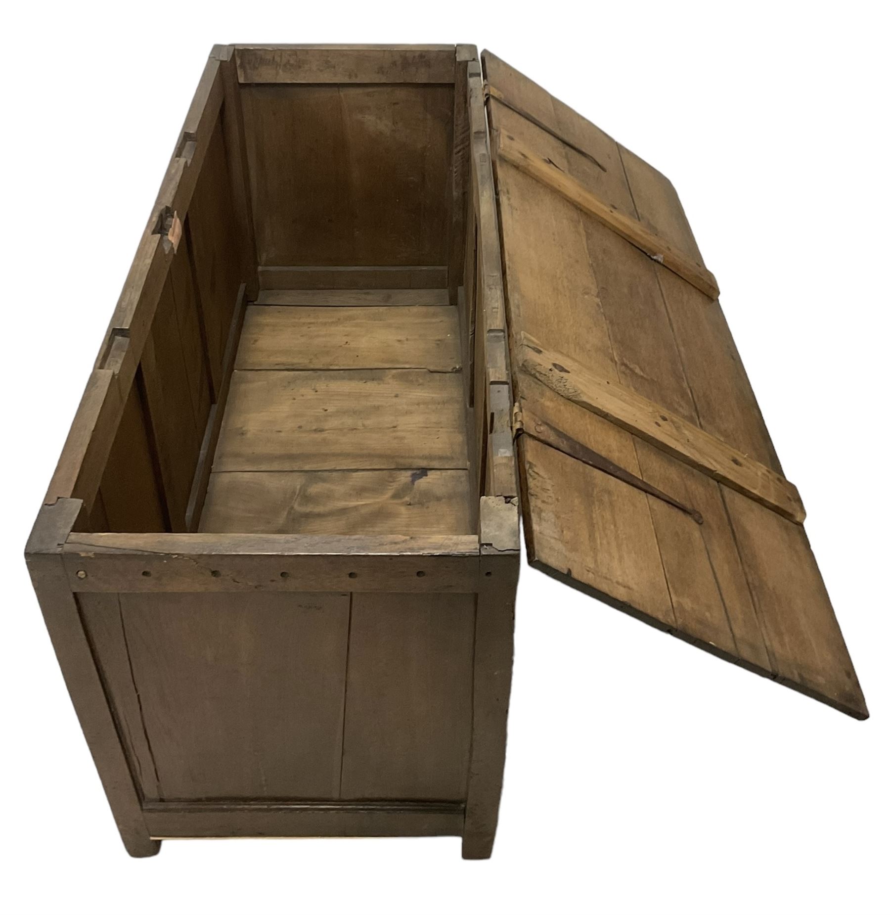 Large 18th century oak coffer or blanket box, hinged lid over triple panelled front, panelled back and sides, on stile supports 