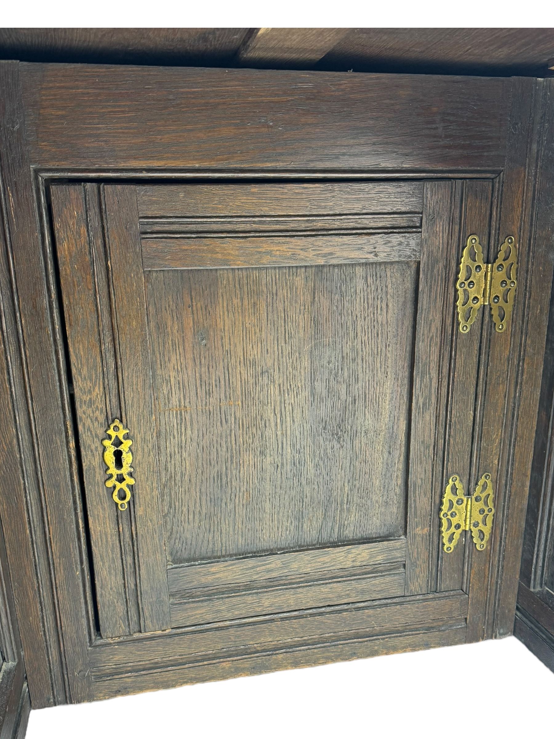 Victorian carved oak kneehole desk, the rectangular top with carved edge, above central drawer with carved front and brass handles, central kneehole with cupboard door, flanked by two banks of three graduating drawers each with similarly carved decoration, on shaped plinth base with castors