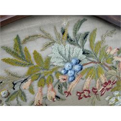 Early 20th century walnut carved needlepoint wall panel, depicting peacock amongst a floral arrangement, framed by carved border with scrolled crest and acanthus leaf accents