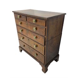 George I walnut chest, moulded rectangular top with book-matched veneers within crossbanding, fitted with two short over four long graduating drawers, moulded drawer fronts with brass handles, on bracket feet, the chest will split into two sections 