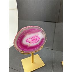 Pair of pink agate slices, polished with rough edges, raised upon gilt metal stands, H20cm