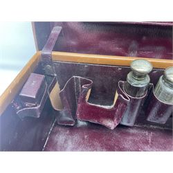 Early 20th century leather bound travelling case, with initials to cover, with fitted interior containing five silver topped glass jars, each engraved with initials, hallmarked The Alexander Clark Manufacturing Co, London 1910 & 1911, case W61cm