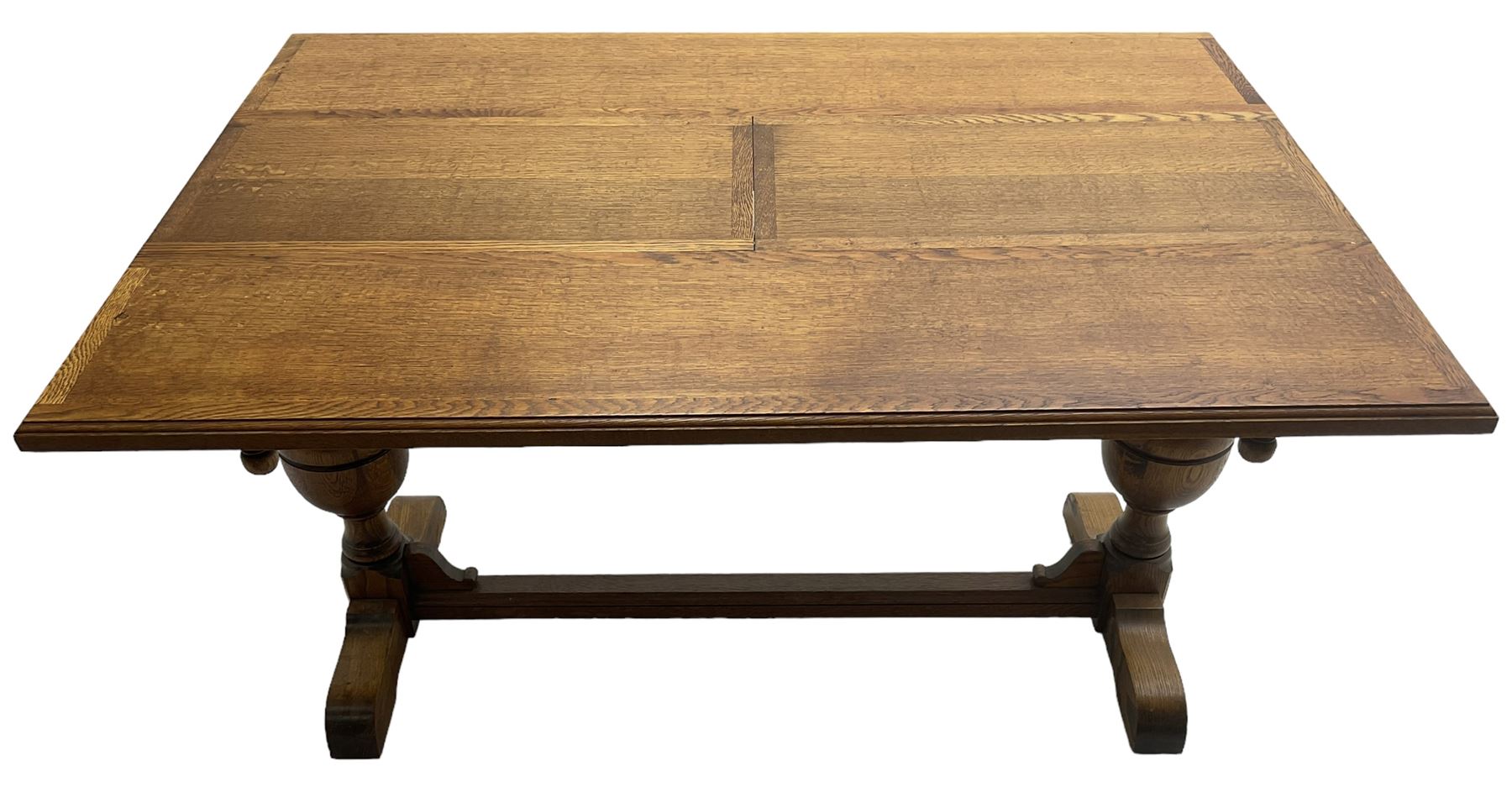 Early 20th century oak 'Ee-zi-Way one motion extending dining table', rectangular top over twin baluster end supports united by stretcher