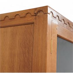 Eagleman - oak bookcase, penny moulded cresting rail over four glazed doors and four panelled doors, fitted with adjustable shelves, on moulded plinth base, panelled sides, carved with eagle signature, by Albert Jeffray, Sessay, Thirsk