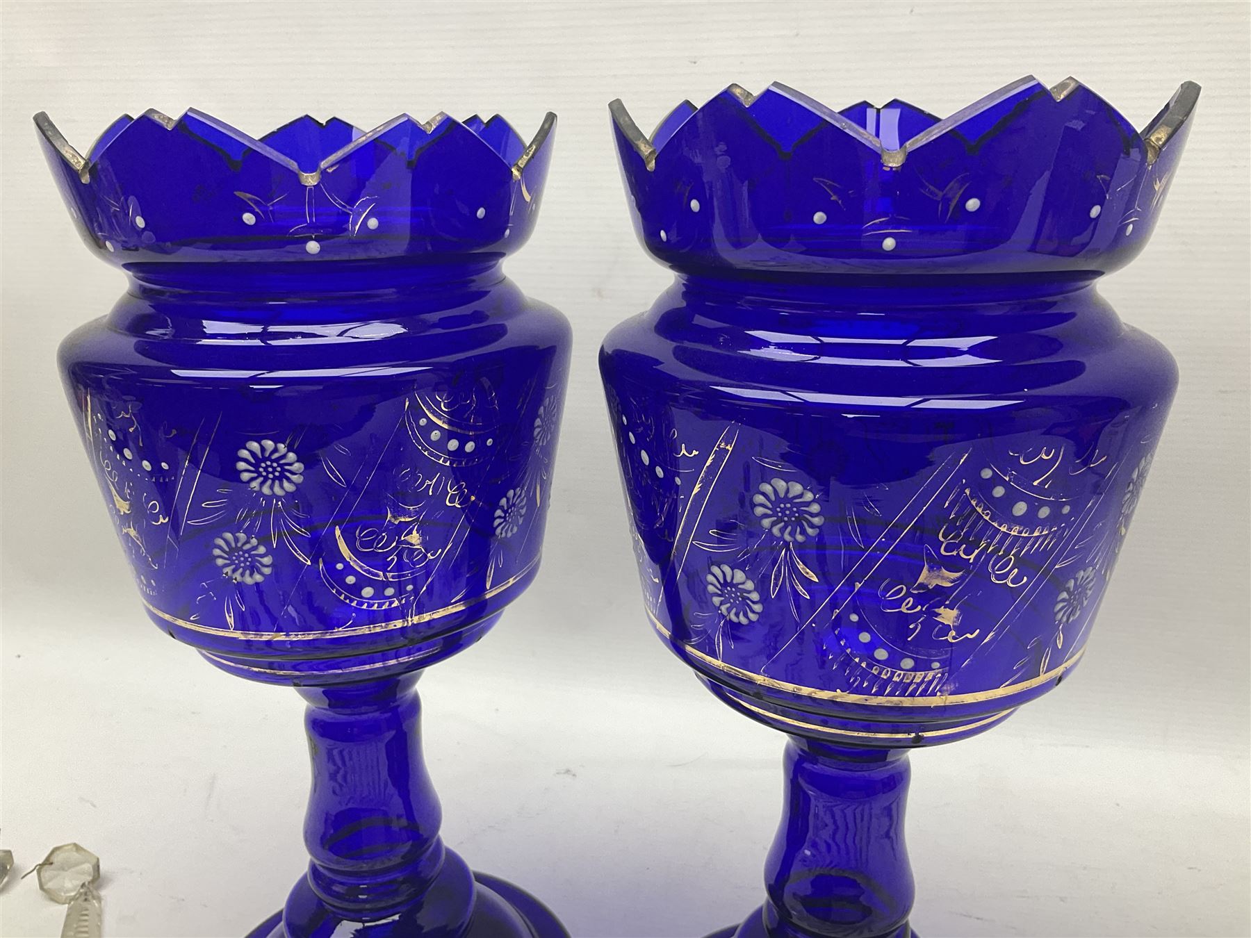 Pair of blue glass lustre vases, painted with white and gilt floral decoration, H32cm