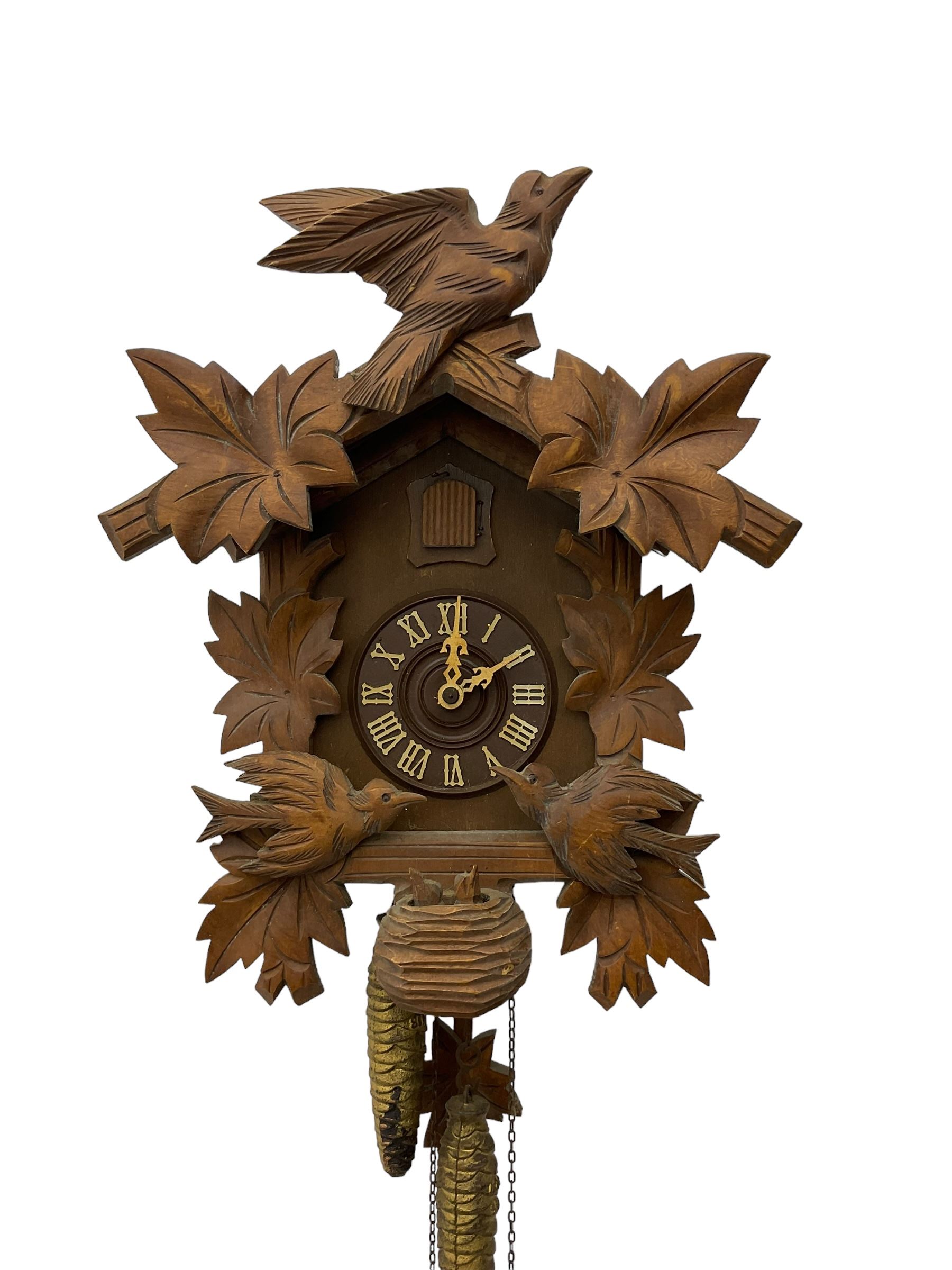 German 1960's cuckoo clock with automata - traditional styled case and dial with a cuckoo sounding the hours and half-hours, twin chain driven movement and automata feature of two carved cuckoos to the front of the case simultaneously moving as the hours are struck. With weights and pendulum.  