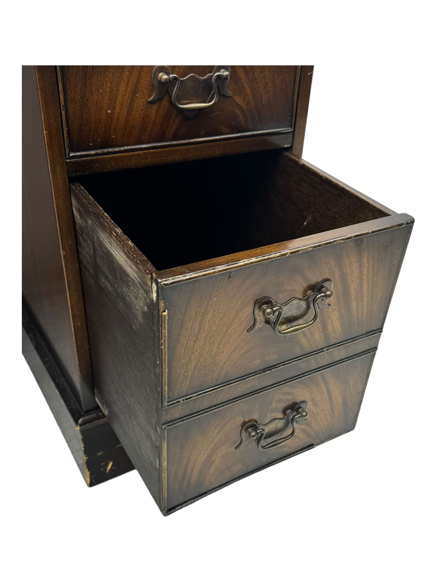 20th century mahogany twin pedestal desk, moulded rectangular top with red leather inset with gilt tooled border, central drawer over kneehole flanked by two banks of four graduating cockbeaded drawers, on plinth base