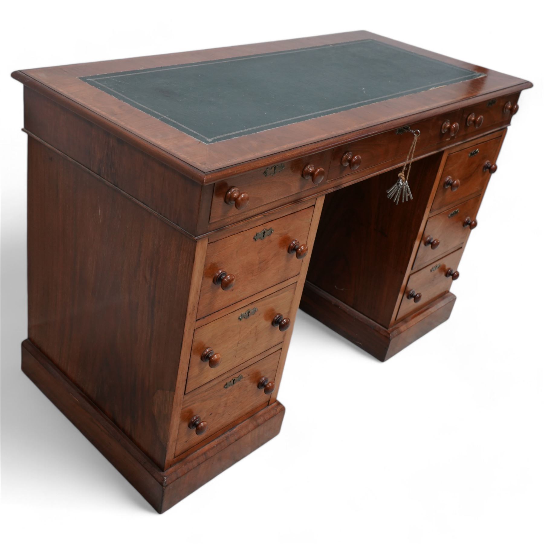 19th century mahogany twin pedestal desk, rectangular top with inset green leather writing surface, fitted with single frieze drawer flanked by four drawers to each side, each with shaped metal escutcheons, on skirted base