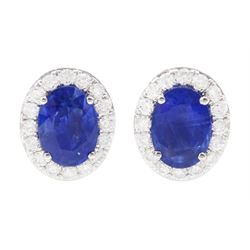 Pair of 18ct white gold oval cut sapphire and round brilliant cut diamond cluster stud ear...