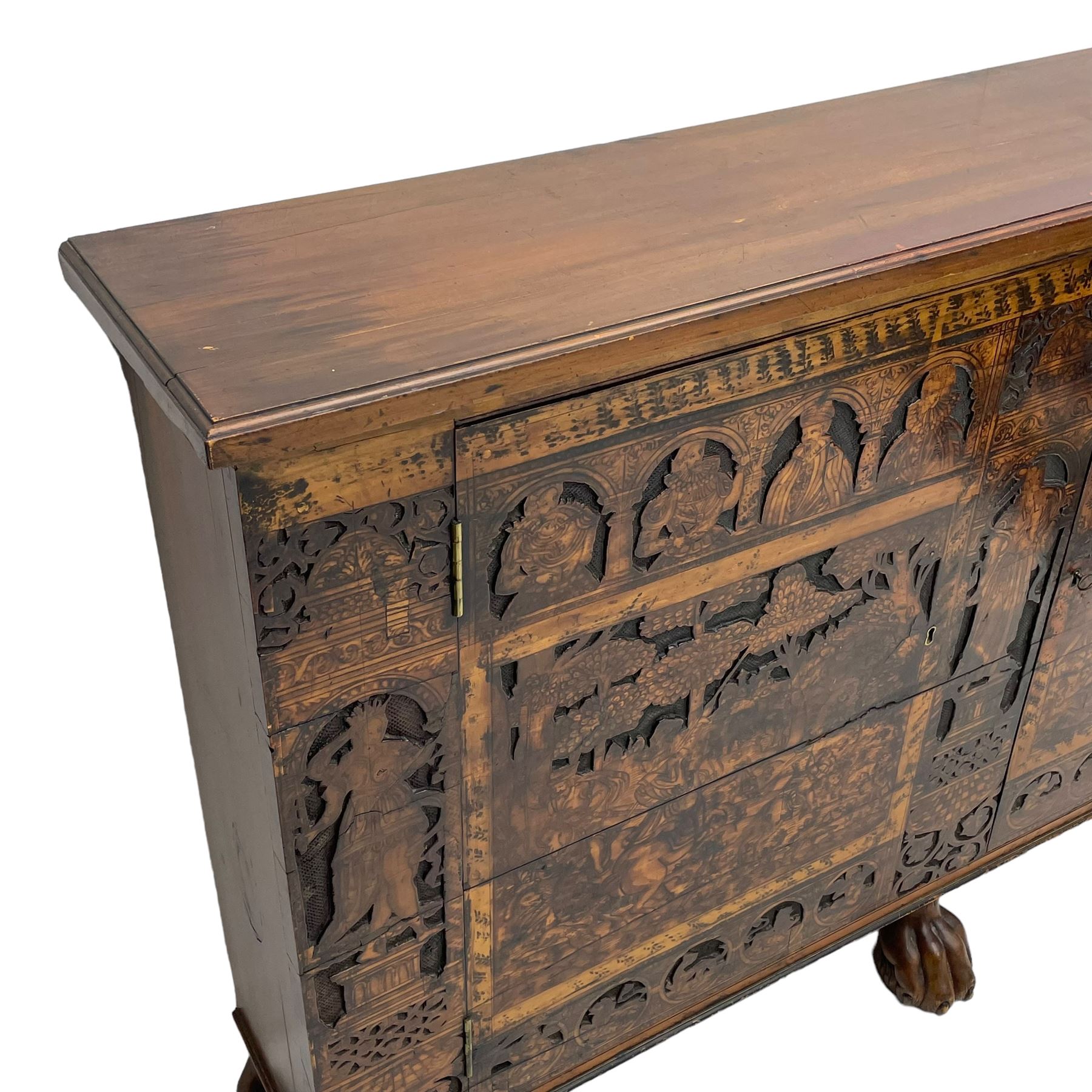 17th century and later cedarwood and pine side cupboard, moulded rectangular top, enclosed by two doors possibly removed and reused from a Venetian Cassone, carved and decorated with penwork, the upper architectural arcade with busts of noblemen, the larger decoration depicting hunters on horseback within woodland landscape with various animals, central and flanking uprights decorated with classical female figures upon pedestals, lower roundels decorated with lion and putto motifs, overall foliate decoration, raised on five hairy paw carved feet, the interior fitted with shelf