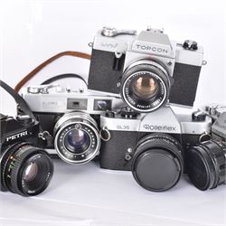 Five SLR cameras, to include Rolleiflex SL35, with a Rollei-HFT Planar 1.8/50 lens serial no. 1246774, Topcon Uni serial no. 5417650, with a Topcor Kogaku UV 1:2 f=53mm lens serial no. 5413035, Bell & Howell Auto35/Reflex Design 237, with a Canon EX 50mm 1:1.8 lens serial no. 92960, Petri GX-1 serial no. 91206945, with a Petri 50mm 1:2.0 lens serial no. 91107428, and a Konica Auto 52 serial no. 1193641, with a Konica Hexanon 1:1.8 f=45mm lens, all in cases 