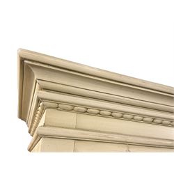 Provincial style cream painted bookcase, projecting cornice over dentil moulding, scalloped frieze above three open shelves, lower section fitted with two drawers, on bracket feet with apron