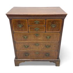 18th century oak and walnut chest, fitted with four small over three long drawers with figured walnut facias, brass handles and plates with engraved decoration, on bracket feet