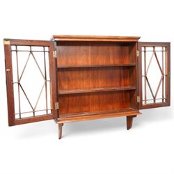 Edwardian inlaid mahogany wall-hanging cabinet, fitted with two astragal glazed doors enclosing two shelves, over shaped brackets