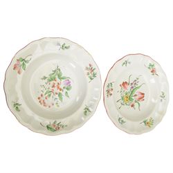 Keller & Guerin Luneville French part tea and dinner service,painted with floral sprays and scattered sprigs within pink edged rims, including covered dish, two meat platters, three coffee pots etc 