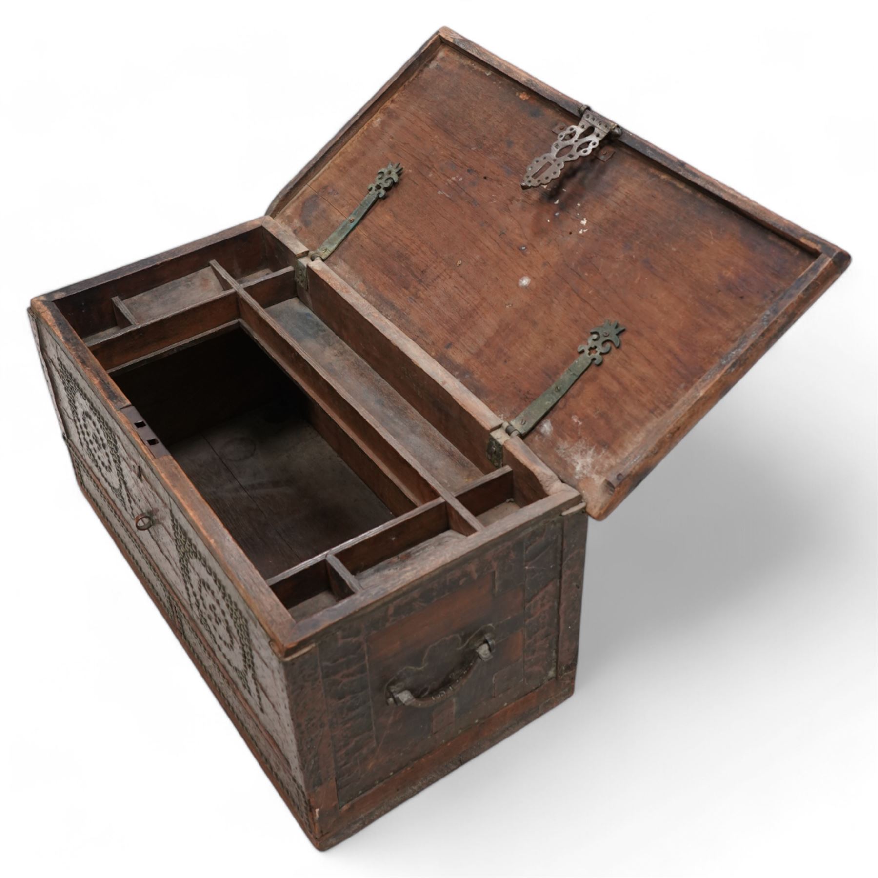 19th century Zanzibar teak and brass mounted chest, hinged lid enclosing divisions, the front decorated with studwork, carrying handles to each side 