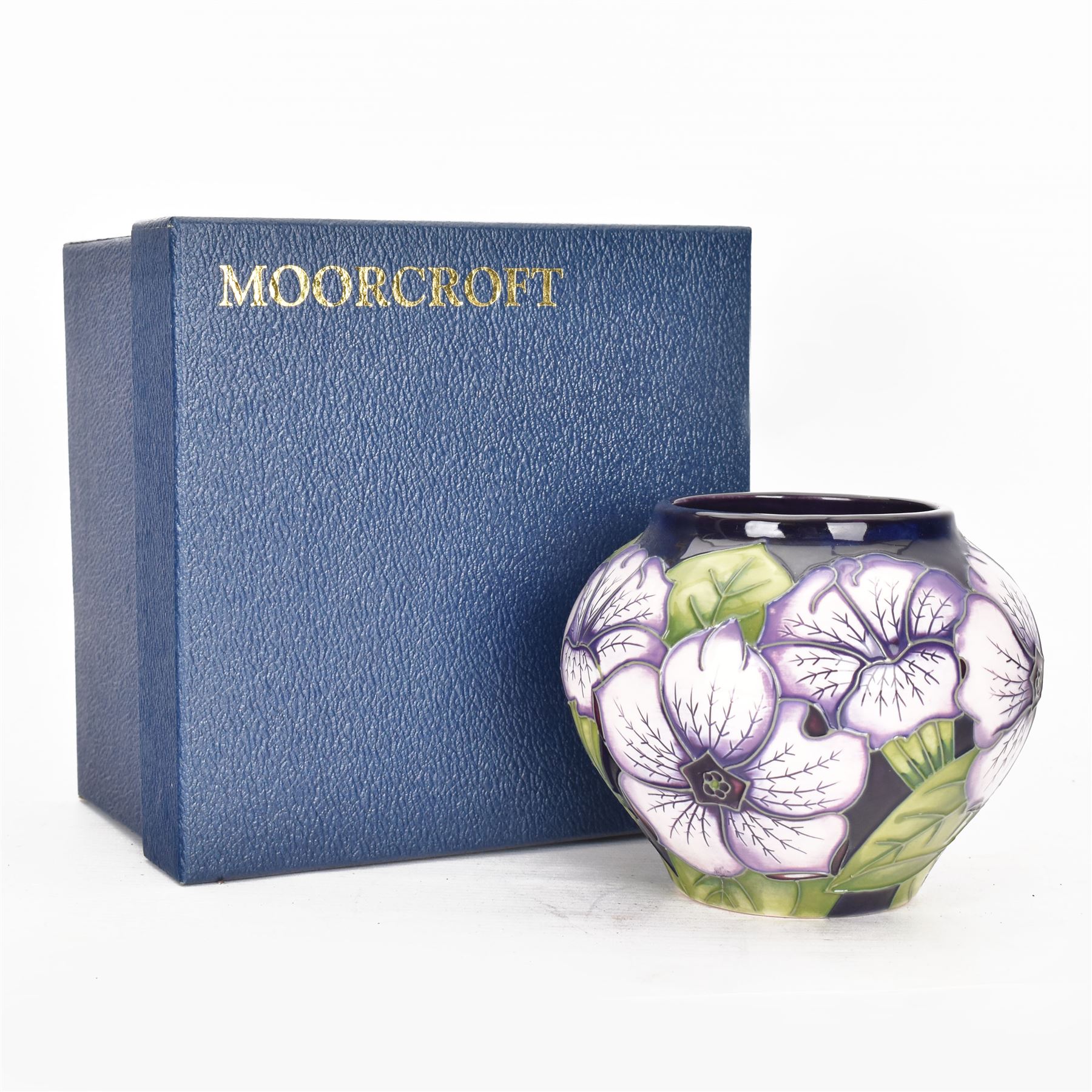 Moorcroft vase in Petunia pattern upon a ble ground, of squat baluster form, marked made for collectables to the base,  with original box, H12cm