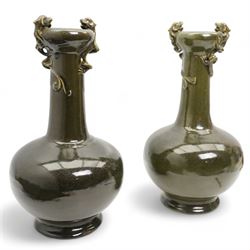 Pair of Chinese green glazed bottle vases, the compressed globular body raised on a short ...