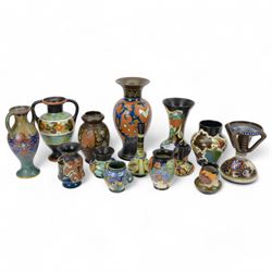 Fourteen Dutch Gouda earthenware vases and similar, all with colourful floral designs upon...