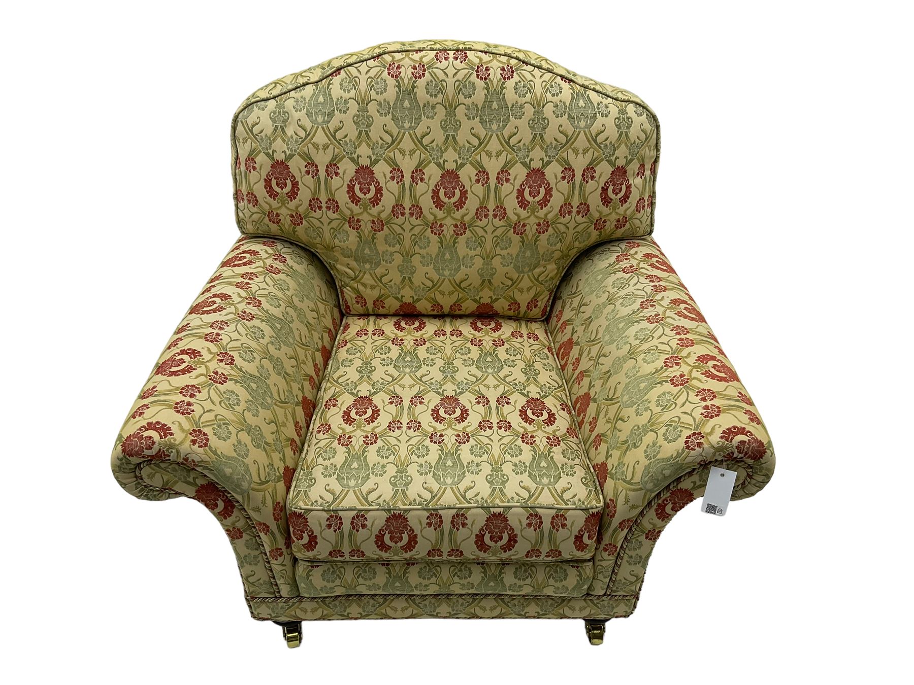 Traditional design two seat sofa, high back with scrolled arms, upholstered in beige fabric with red and green damask motifs, on castor supports (L178cm, D100cm, H89cm); matching armchair (L109cm, D89cm, H89cm)