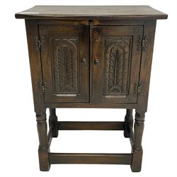 Small oak hutch cupboard, fitted with two carved doors