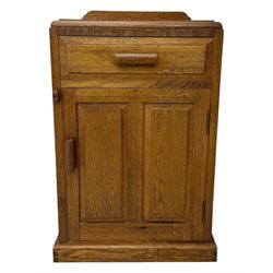 Arts & Crafts period oak bedside cupboard, raised back over moulded top, fitted with single drawer over panelled cupboard, panelled sides, on chamfered plinth base 