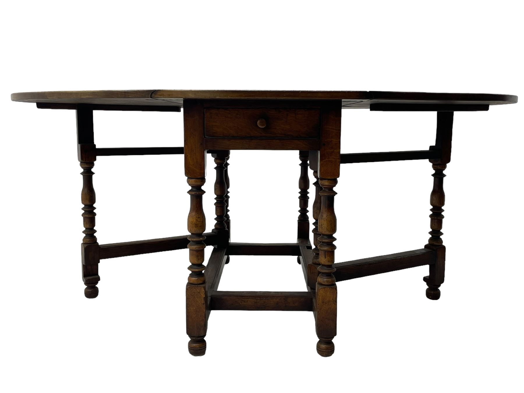 18th century oak dining table, oval drop-leaf top on gate-leg action base, turned supports united by turned stretchers, fitted with single end drawer