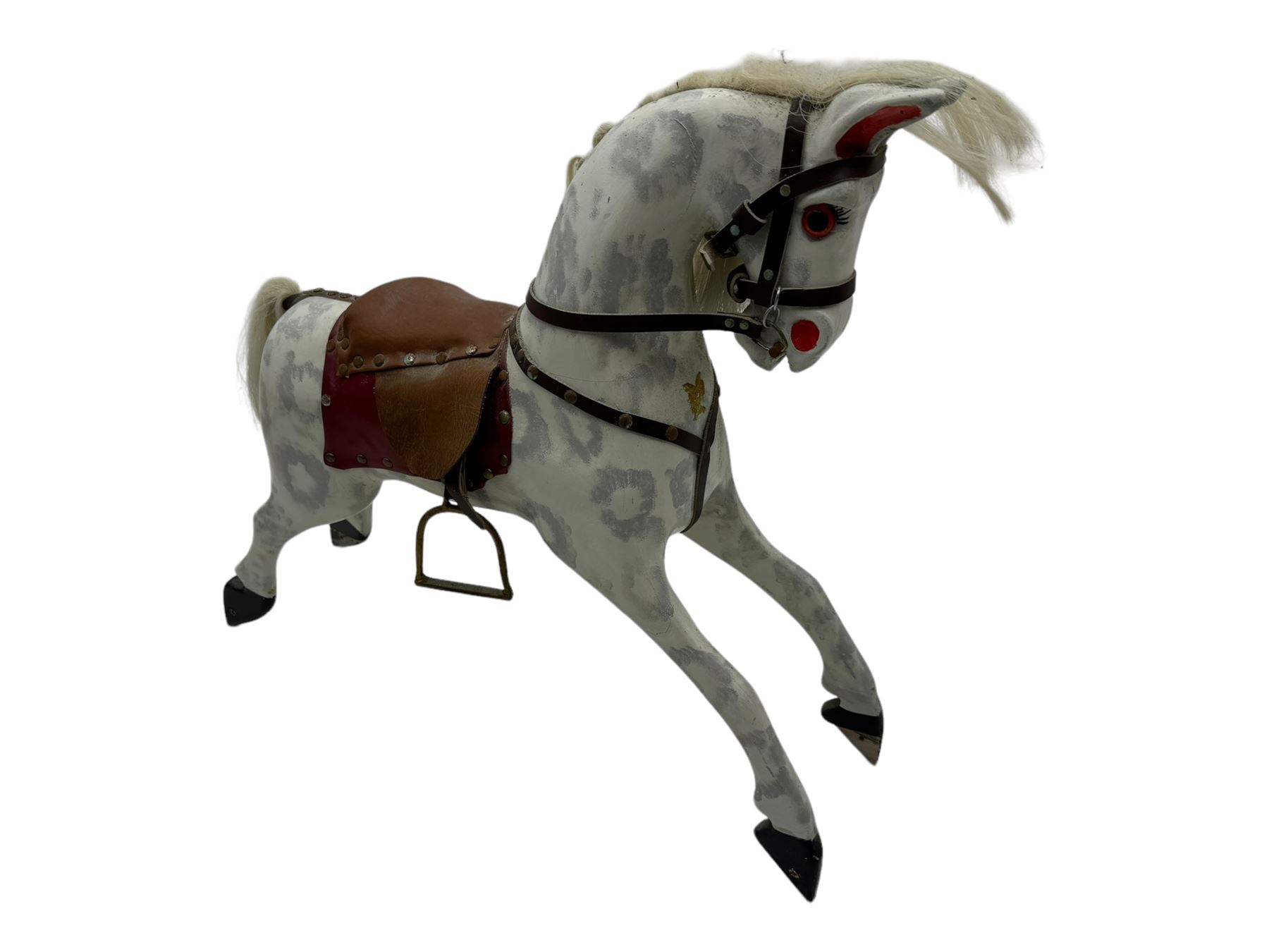 Mid 20th century rocking horse, dappled grey painted horse with applied mane and tail, red leather saddle and bridle accented with brass studs, supported by a stained wooden frame with turned supports and iron brackets, mounted on rockers